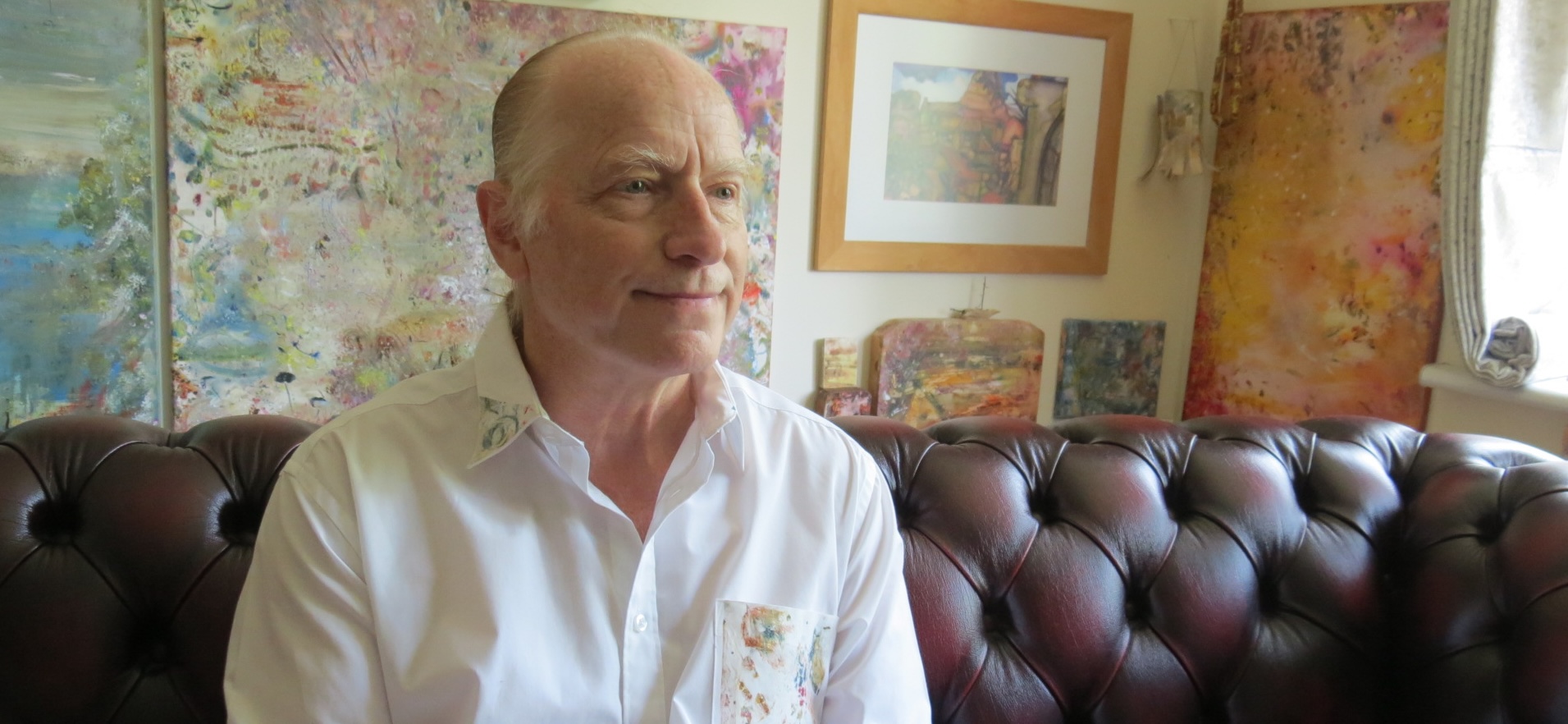 David Sherwin in his studio, surrounded by his paintings