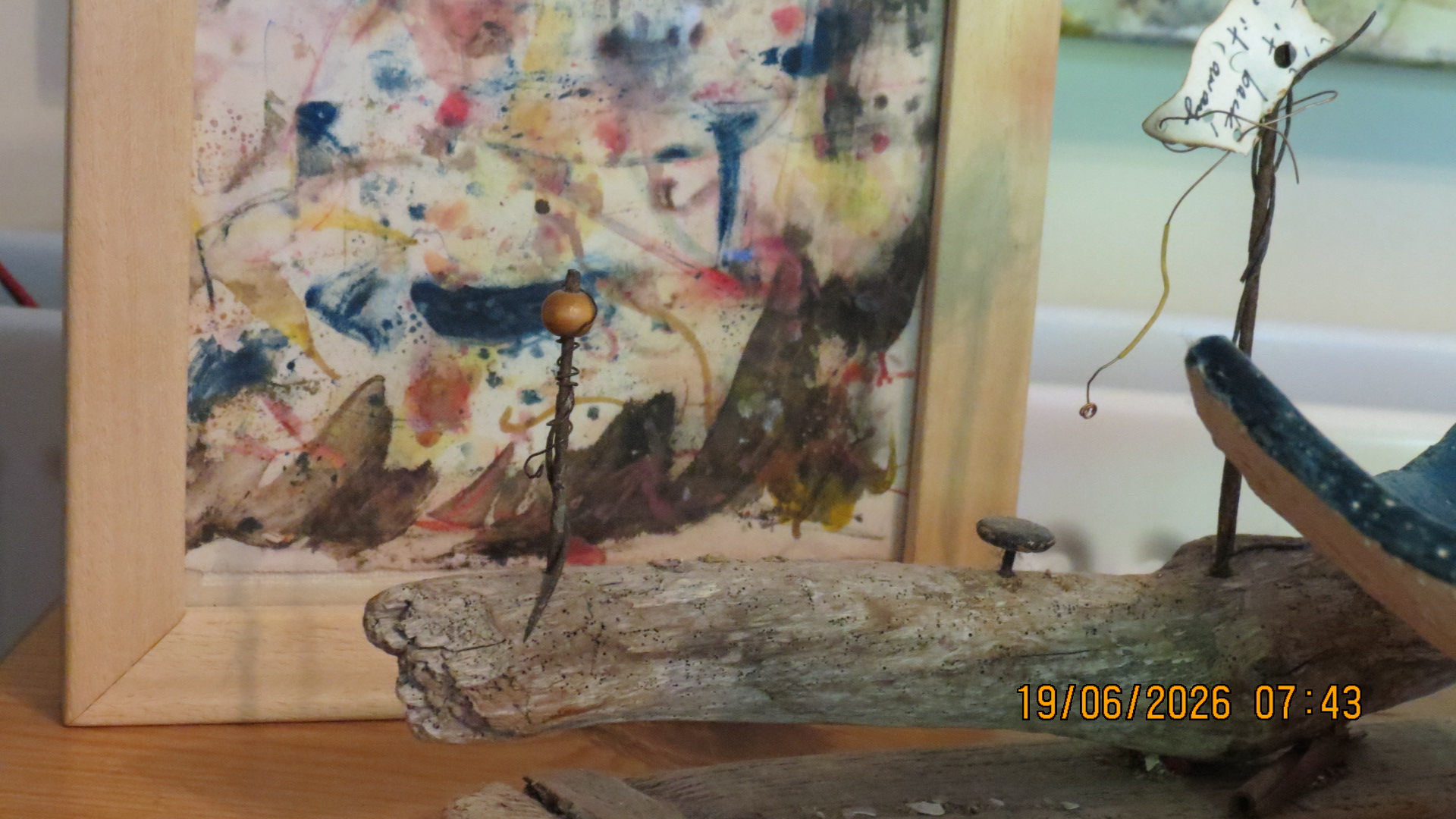 Driftwood boat assemblage with abstract watercolour backdrop
